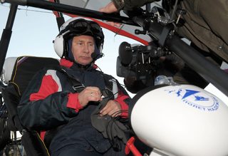 Russian President Vladimir Putin sits in a motorised deltaplane at Yamalo-Nenets district