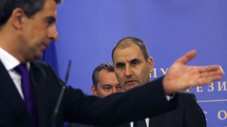 Bulgarian President Plevneliev gestures to interior minister Tsvetan Tsvetanov during a news conference in Sofia