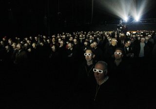 Members of the audience wear 3d glasses while watching German electronic band Kraftwerk perform with a 3d stage set at the Tate Modern in London