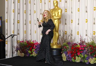 Adele Adkins of Britain leaves the stage with her Oscar for Best Original Song for "Skyfall" at the 85th Academy Awards in Hollywood