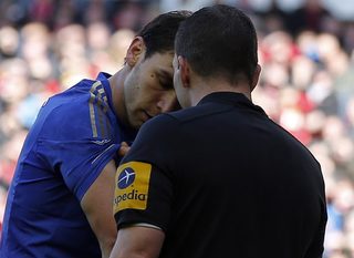 Chelsea's Ivanovic shows his arm to referee Friend after an incident with Liverpool's Suarez during their English Premier League soccer match in Liverpool