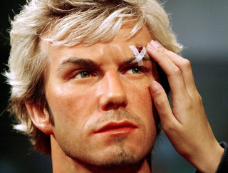 VISITOR TOUCHES A WAX FIGURE OF ENGLAND'S DAVID BECKHAM AT MADAME TUSSAUD'S IN HONG KONG