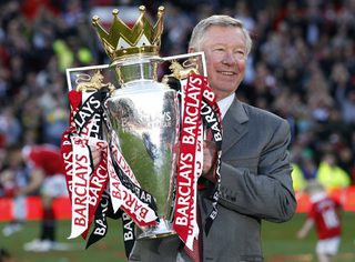 File photo of Manchester United's manager Ferguson holding the English Premier League trophy following their English Premier League soccer match against Blackpool at Old Trafford in Manchester