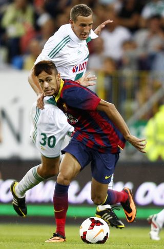 Barcelona's Neymar and Lechia Gdansk's Maciej Kostrzewa fight for the ball during their friendly soccer match in Gdansk