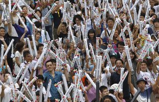Participants wave inflatable clappers during an event celebrating Tokyo being chosen to host the 2020 Olympic Games, at Tokyo Metropolitan Government Building in Tokyo