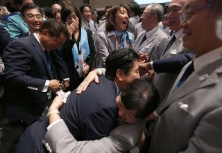 Prime Minister Shinzo Abe of Japan celebrates with members of the Tokyo bid committee after Jacques Rogge, president of the International Olympic Committee, announced Tokyo as the city to host the 2020 Summer Olympic Games in Buenos Aires