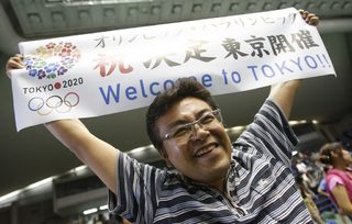 A man celebrates after hearing that Tokyo had been chosen to host the 2020 Olympic Games during a public viewing event in Tokyo