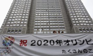 A huge banner reading "Celebration 2020 Olympics" is set up at Tokyo Metropolitan Government Building in Tokyo