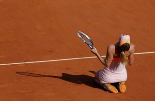 Maria Sharapova of Russia reacts after winning her women's singles final match against Simona Halep of Romania at the French Open tennis tournament at the Roland Garros stadium in Paris