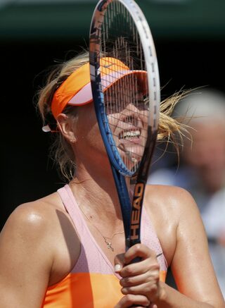 Maria Sharapova of Russia returns the ball to Simona Halep of Romania during their women's singles final match at the French Open tennis tournament at the Roland Garros stadium in Paris