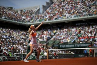Maria Sharapova of Russia serves to Simona Halep of Romania during their women's singles final match at the French Open tennis tournament at the Roland Garros stadium in Paris