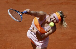 Maria Sharapova of Russia serves to Simona Halep of Romania during their women's singles final match at the French Open tennis tournament at the Roland Garros stadium in Paris