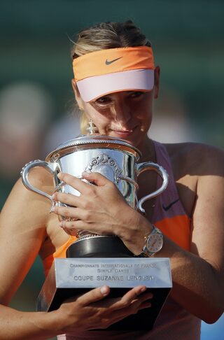 Maria Sharapova of Russia holds the trophy as she poses during the ceremony after defeating Simona Halep of Romania during their women's singles final match to win the French Open tennis tournament in Paris