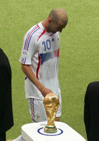 France's Zidane walks past the World Cup Trophy during half-time in their World Cup 2006 final soccer match against Italy in Berlin