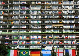 National flags adorn a residential apartment block in Berlin