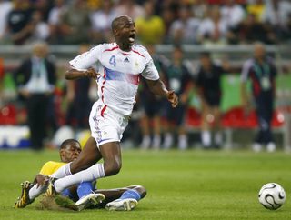Brazil's Juan tackles France's Patrick Vieira during their World Cup 2006 quarter-final soccer match in Frankfurt