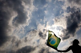 A soccer fan of Brazil waves a flag during the World Cup 2006 soccer match between Brazil and Ghana at a fan festival in Frankfurt