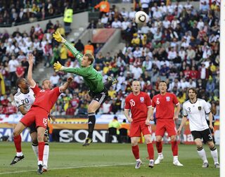 England's Matthew Upson  heads in the first goal past Germany's goalkeeper Manuel Neuer during their 2010 World Cup second round soccer match at Free State stadium in Bloemfontein