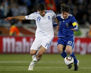 Greece's Papastathopoulos fights for the ball with Argentina's Messi during a 2010 World Cup Group B soccer match in Polokwane