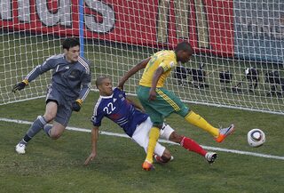 South Africa's Mphela scores a goal past France's Clichy and goalkeeper Lloris during the 2010 World Cup Group A soccer match in Bloemfontein