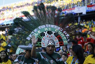 A fan gestures as he attends the opening ceremony of the 2014 World Cup at the Corinthians arena in Sao Paulo