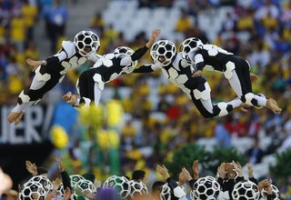 Performers are thrown into the air during the 2014 World Cup opening ceremony at the Corinthians arena in Sao Paulo