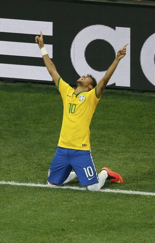Brazil's Neymar celebrates after scoring a penalty against Croatia during the 2014 World Cup opening match at the Corinthians arena in Sao Paulo