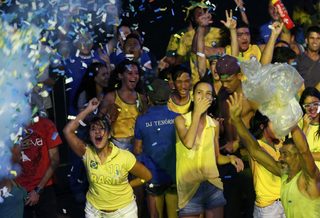 Brazilian soccer fans react while watching the opening soccer match between Brazil and Croatia in a fan zone during the 2014 World Cup in Recife