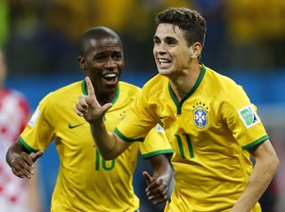 Brazil's Ramires and Brazil's Oscar celebrate during the 2014 World Cup opening match between Brazil and Croatia at the Corinthians arena in Sao Paulo