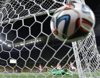Croatia's goalkeeper Stipe Pletikosa lies on the ground after Brazil's Oscar scored a goal during their 2014 World Cup opening match at the Corinthians arena in Sao Paulo