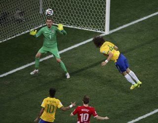 Brazil's David Luiz misses a header during their 2014 World Cup opening match against Croatia at the Corinthians arena in Sao Paulo