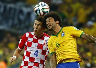 Croatia's Ivan Perisic (L) and Brazil's Marcelo fight for the ball during their 2014 World cup opening match at the Corinthians arena in Sao Paulo
