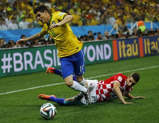 Brazil's Oscar is fouled by Croatia's Vrsaljko during their 2014 World Cup opening match at the Corinthians arena in Sao Paulo