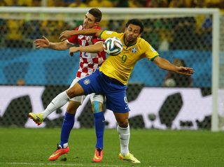 Croatia's Vrsaljko and Brazil's Fred fight for the ball during their 2014 World cup opening match at the Corinthians arena in Sao Paulo