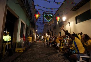 Brazilians celebrate a goal as they watch the 2014 World Cup soccer match between Brazil anc Croatia at Pelourinho neigborhood in Salvador