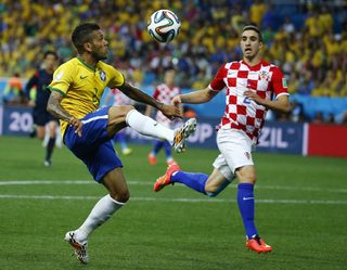 Croatia's Vrsaljko and Brazil's Alves fight for the ball during their 2014 World cup opening match at the Corinthians arena in Sao Paulo