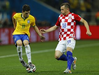 Brazil's Oscar fights for the ball with Croatia's Ivica Olic during the 2014 World Cup opening match between Brazil and Croatia at the Corinthians arena in Sao Paulo