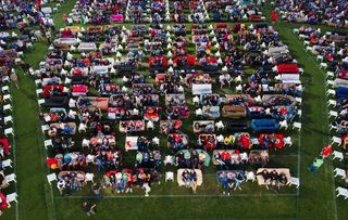 People sit on sofas as they watch the opening game of the 2014 World Cup between Brazil and Croatia, during a public viewing event in Berlin