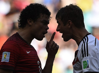Portugal's Pepe argues with Germany's Mueller during their 2014 World Cup Group G soccer match at the Fonte Nova arena in Salvador