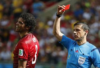 Portugal's Pepe is shown the red card by referee Mazic of for committing a rough foul against Germany's Thomas Mueller (not pictured) during their 2014 World Cup Group G soccer match at the Fonte Nova arena in Salvador