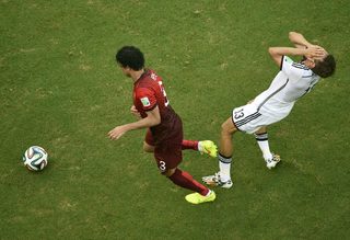 Germany's Thomas Mueller reacts after being hit by Portugal's Pepe during World Cup Group G soccer match at Fonte Nova arena
