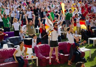 People celebrate a German goal as they watch it playing against Portugal in a World Cup soccer match at a public viewing event at the Alte Foersterei stadium in Berlin