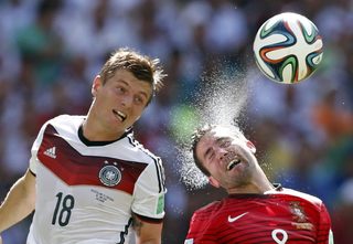 Germany's Kroos and Portugal's Moutinho fight for the ball during their 2014 World Cup Group G soccer match at the Fonte Nova arena in Salvador