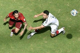 Portugal's Hugo Almeida fights for the ball with Germany's Mats Hummels during their 2014 World Cup Group G soccer match at the Fonte Nova arena