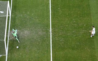 Germany's Thomas Mueller scores past Portugal goalkeeper Rui Patricio during World Cup Group G soccer match at Fonte Nova arena