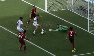 Germany's Mueller shoots to score against Portugal for his hat-trick during their 2014 World Cup Group G soccer match at the Fonte Nova arena in Salvador