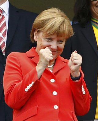 German Chancellor Angela Merkel gestures before their 2014 World Cup Group G soccer match against Portugal at the Fonte Nova arena in Salvador