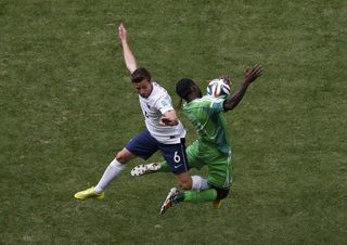 France's Cabaye fights for the ball with Nigeria's Moses during their 2014 World Cup round of 16 game in Brasilia;France's Cabaye fights for the ball with Nigeria's Moses during their 2014 World Cup round of 16 game in Brasilia