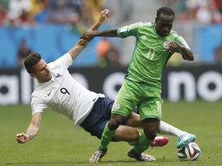 France's Giroud fights for the ball with Nigeria's Moses during their 2014 World Cup round of 16 game at the Brasilia national stadium in Brasilia