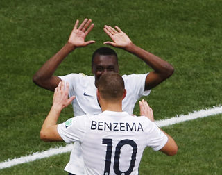 France's Matuidi celebrates with teammate Benzema after Nigeria's Yobo scored an own goal during their 2014 World Cup round of 16 game at the Brasilia national stadium in Brasilia